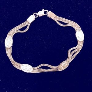 Silver bracelet with silver conchos